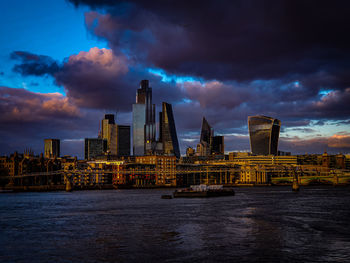 View of buildings in city at sunset