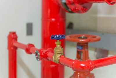 Close-up of valves on red pipes