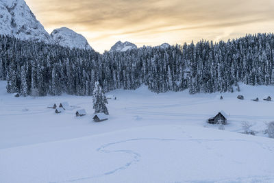 Scenic view of snow covered field against sky