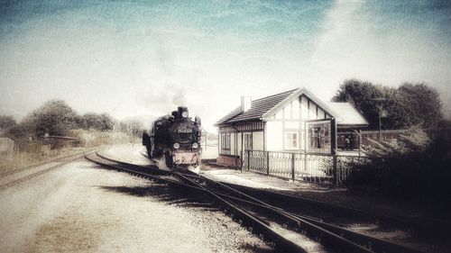 Train on railroad track against sky