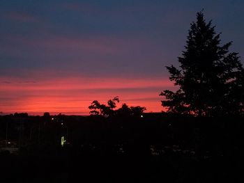 Silhouette trees against sky during sunset