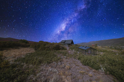 Scenic view of land against sky at night