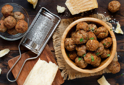 High angle view of fried food and cheese on table