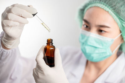 Midsection of dentist examining patient in laboratory