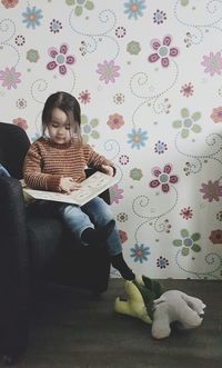 Woman sitting on sofa at home