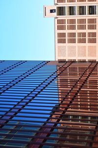 Low angle view of modern building against clear blue sky