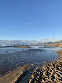 Scenic view of sea against blue sky