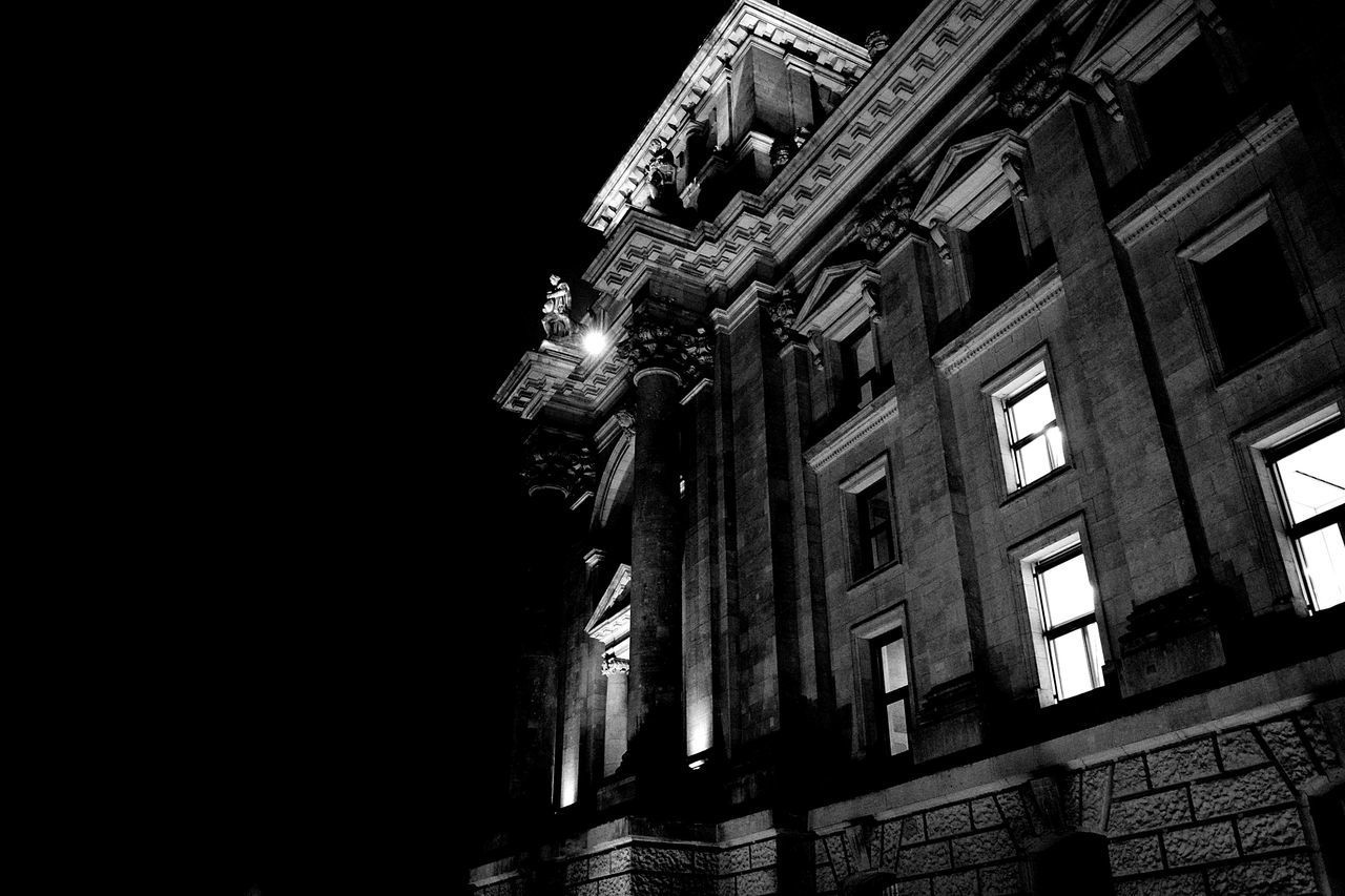 LOW ANGLE VIEW OF ILLUMINATED BUILDING AGAINST SKY AT NIGHT