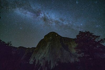 Low angle view of rock formations against sky at night