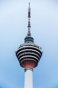 Low angle view of communications tower against blue sky