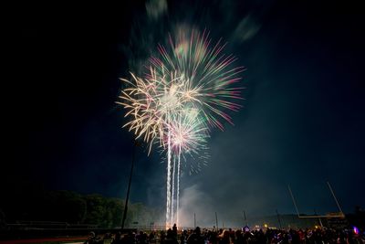 Low angle view of firework display at night