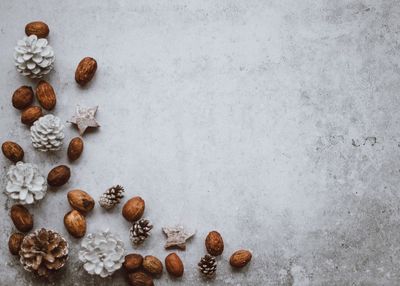 Directly above shot of pine cones and walnuts on table during christmas