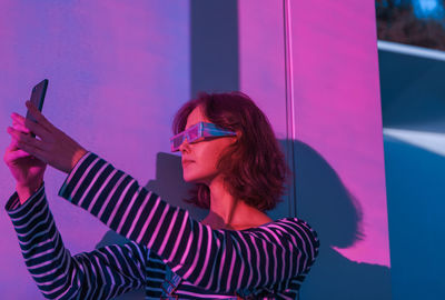 Portrait of young woman using mobile phone outdoors