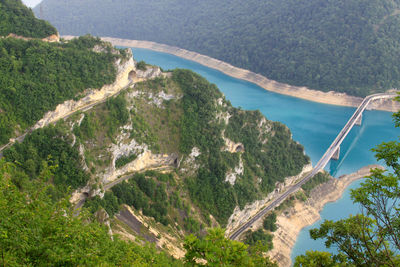 Descending road and bridge at piva lake pivsko jezero, in the mountains in montenegro, durmitor road