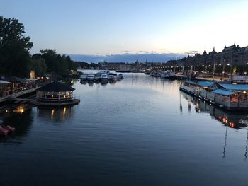 Boats in harbor at dusk