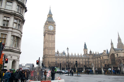 People in city against sky