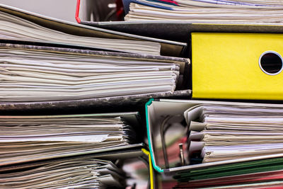 Full frame shot of stacked papers in files at office