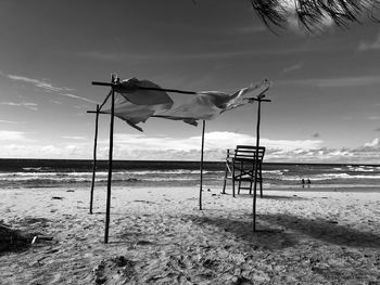 Lifeguard hut on beach against sky