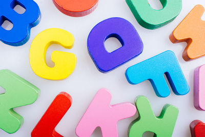 High angle view of multi colored alphabets on table