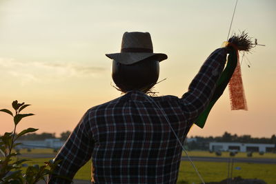 Scarecrow against sky during sunset