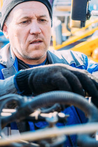 Close-up of man repairing car