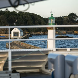 Built structure by lake against sky