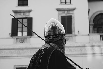 Portrait of man standing against building in city