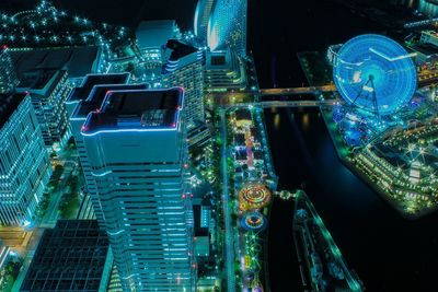 High angle view of illuminated buildings in city at night