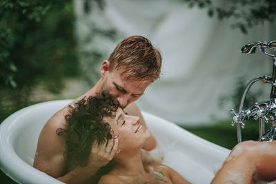 Couple in bathtub outdoors