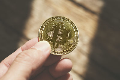 Close-up of hand holding coins