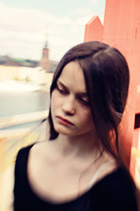 Close-up of young woman against sky