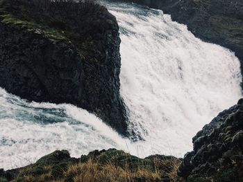 Low angle view of waterfall against the sky