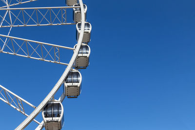 Low angle view of security camera against clear blue sky