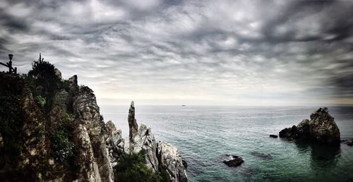 View of calm sea against cloudy sky