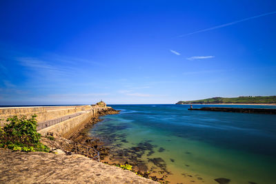 Scenic view of sea against blue sky