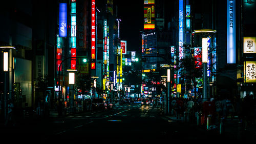 Illuminated city street at night