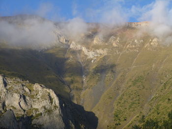 Aerial view of land and mountains against sky