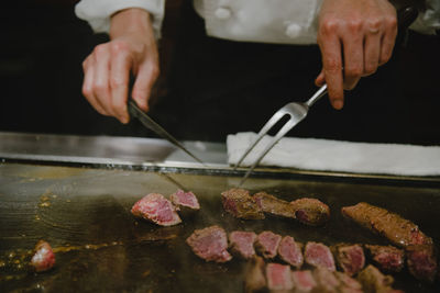 Midsection of man preparing food