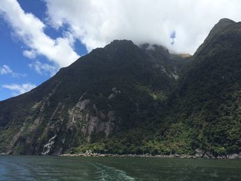 Scenic view of river and mountains against sky