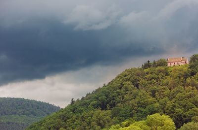 Scenic view of mountains against cloudy sky