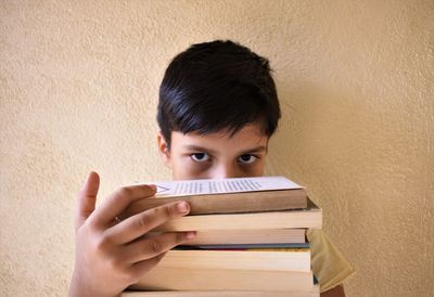 Portrait of boy sitting on wall
