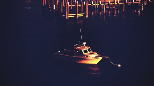 Close-up of illuminated ship moored at night