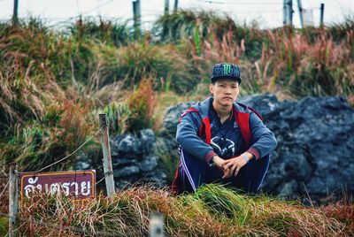 Full length of man sitting on field