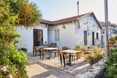 Cafe in an old house with tables in the rays of the setting sun