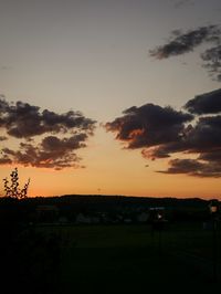 Scenic view of silhouette field against sky during sunset