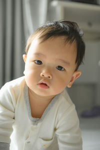 Portrait of cute baby girl at home