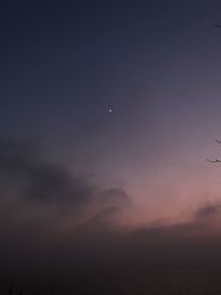 Low angle view of moon at sunset