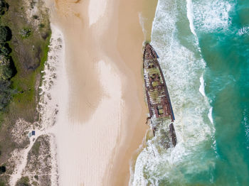 Aerial view of shipwreck on beach