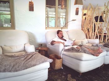 Woman relaxing on lounge chair at spa