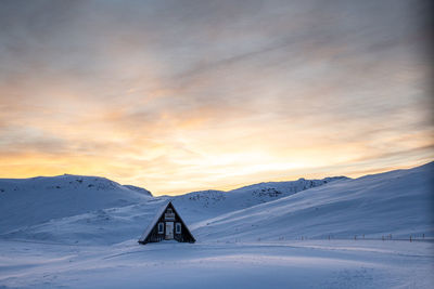 Scenic view of snowcapped mountains against sky during sunset